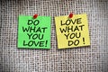 Do what you love, love what you do on colored adhesive notes Ã¢â¬â burlap background Royalty Free Stock Photo